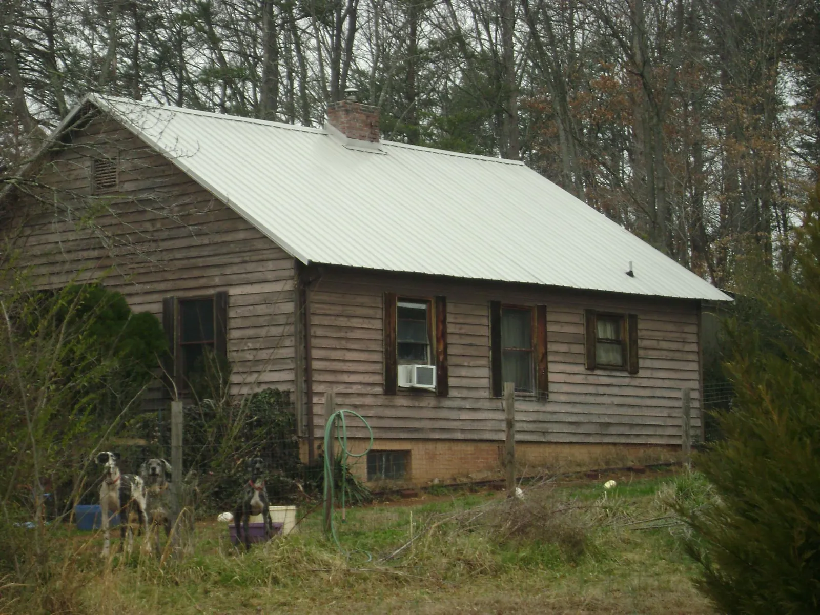 White metal roof on an old wood sided farmhouse, from a Metal Roof Installation job in Sasser